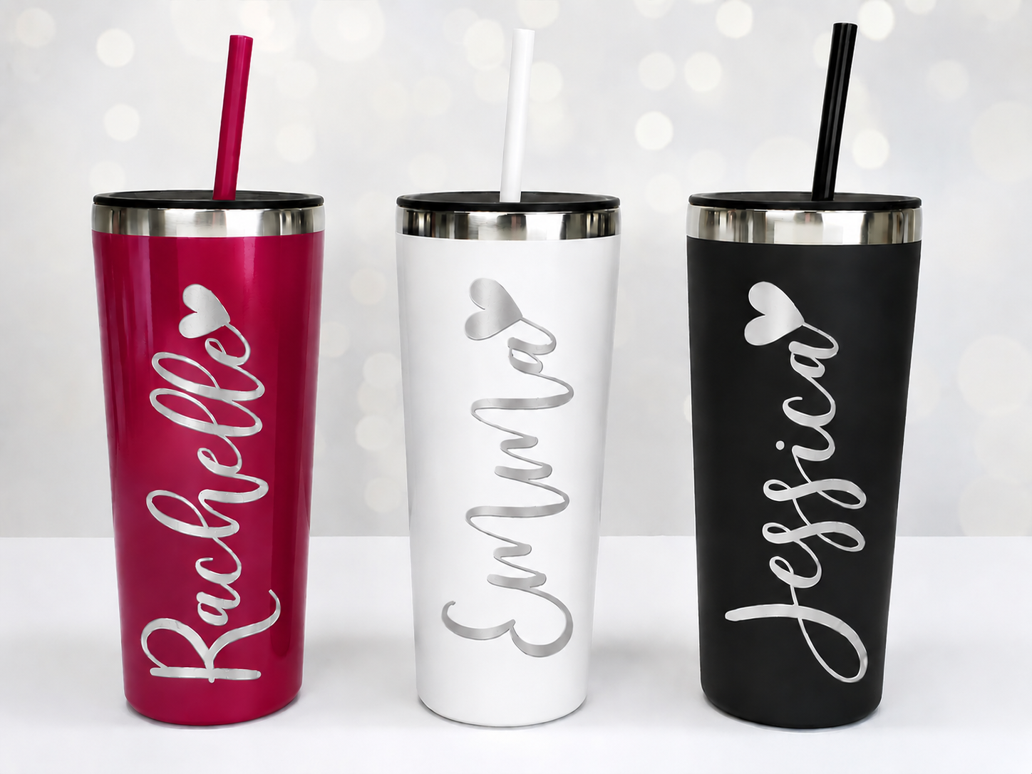 Three personalized tumblers with names 'Rachelle', 'Emma', and 'Jessica' on a white background.